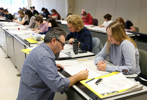 Instructor Joshua Wilichowski talks with a student in the Design Drawing and Concept Visualization class at UW-Stout.