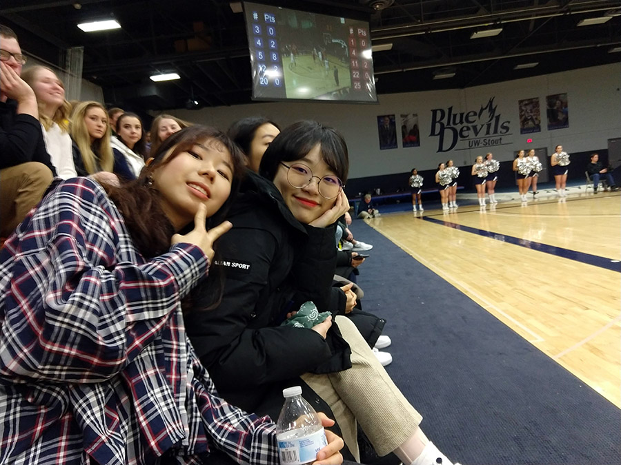 The South Korean students attend a UW-Stout basketball game as part of Winter in the Midwest, a cultural and educational exchange.