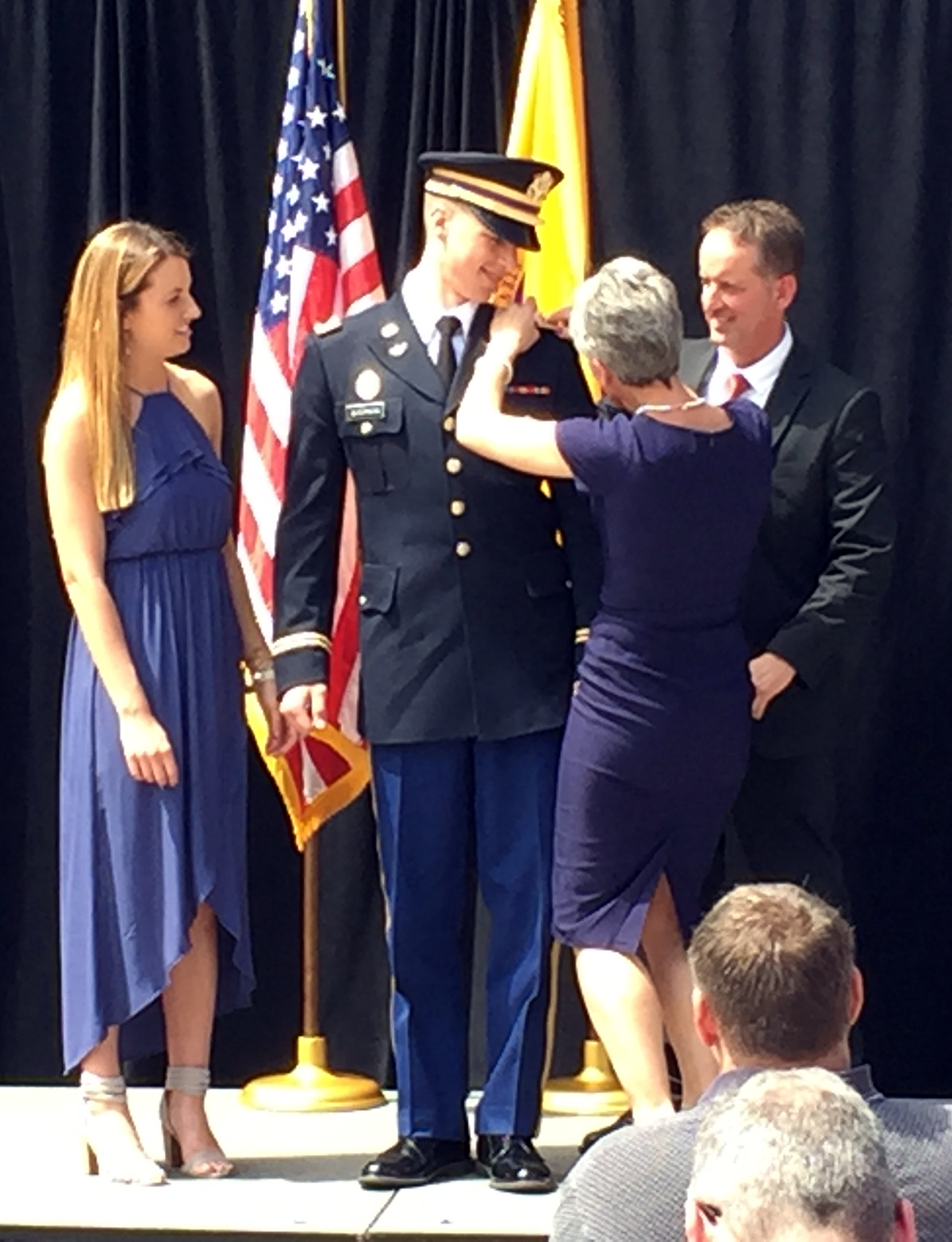 Cole Quednow receives his bars from is parents Tom and Carmen Quednow as his girlfriend, Lauren Rusch, at left, looks on.