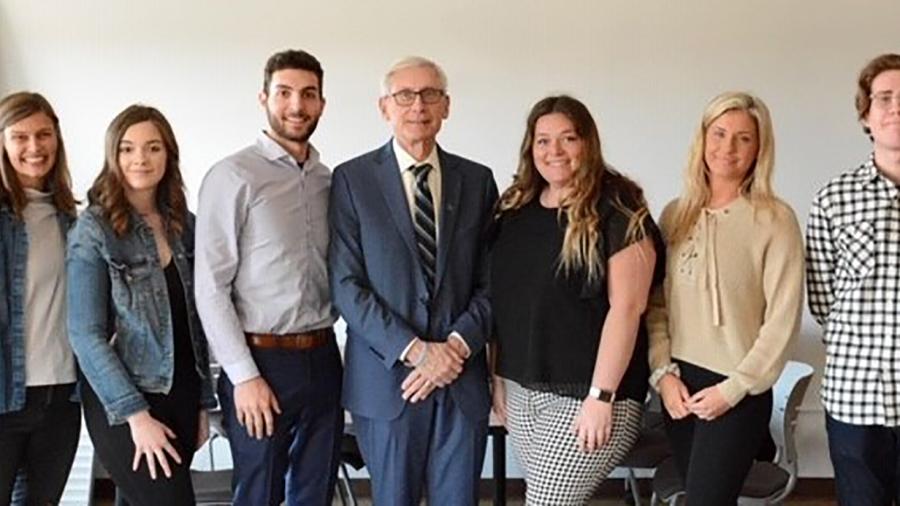 From left, UW-Stout Fostering Success students Kate McCraig, Lisa Driver, Cameron Hunter, Katie Gordon, Olivia Johnston and Adam Warner meet with Gov. Tony Evers during his 2020 visit to campus.