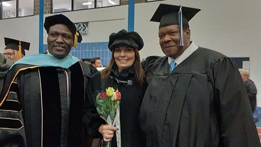 DeAngelo and his wife, Shelly, celebrate Golden's graduation with Associate Professor Brian Oenga.