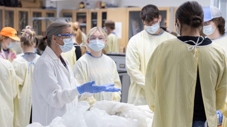 Dr. Alex Hall with students in the Cadaver Lab
