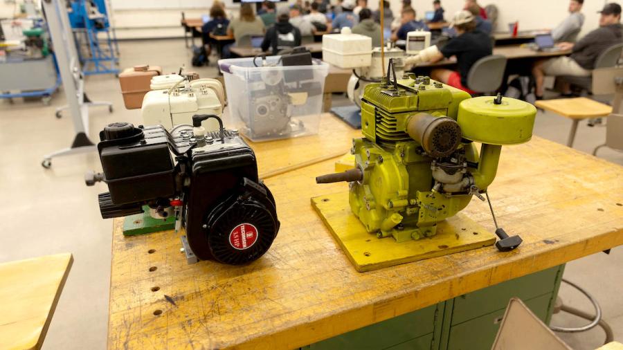 Six small motor engines on a worktable