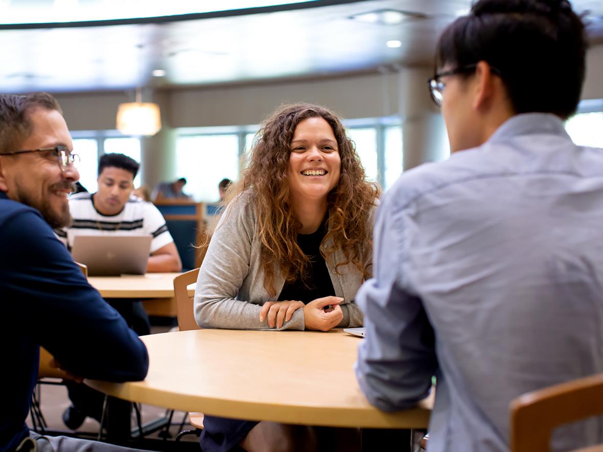 Dominique Vargas talks with a student, right, and Darren Ward, left, a first-year student adviser, at the UW-Stout student center. 