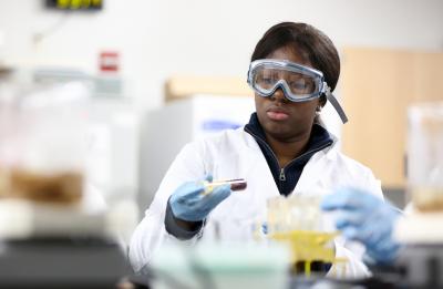UW-Stout student in a biochemistry lab.