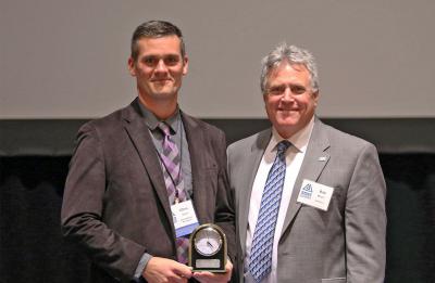 Chris Grun receiving an Outstanding Alumni award, 2017